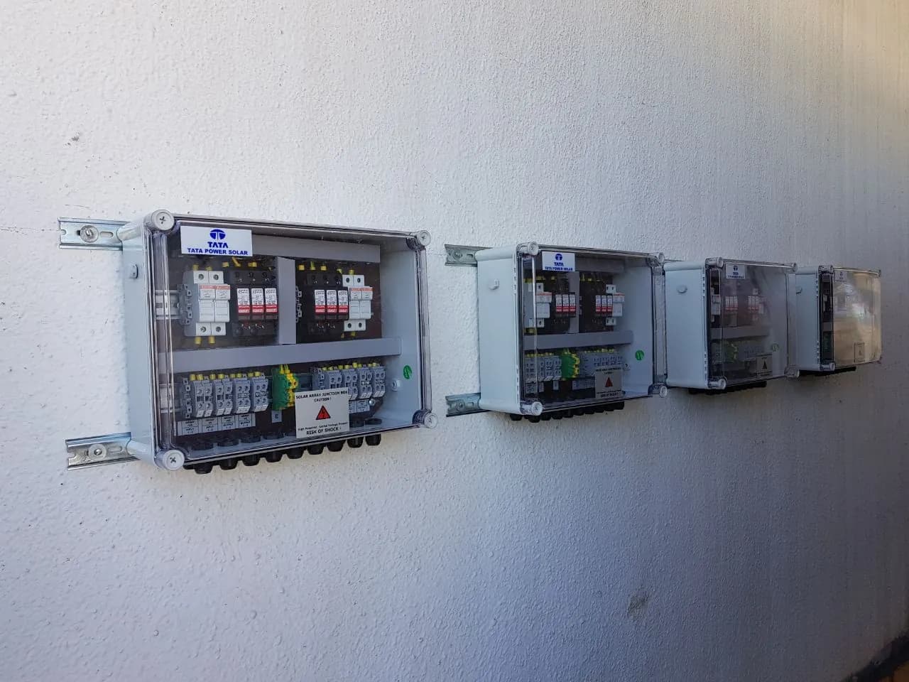 Wall-mounted Tata Power Solar array junction boxes at the Pernod Ricard project
