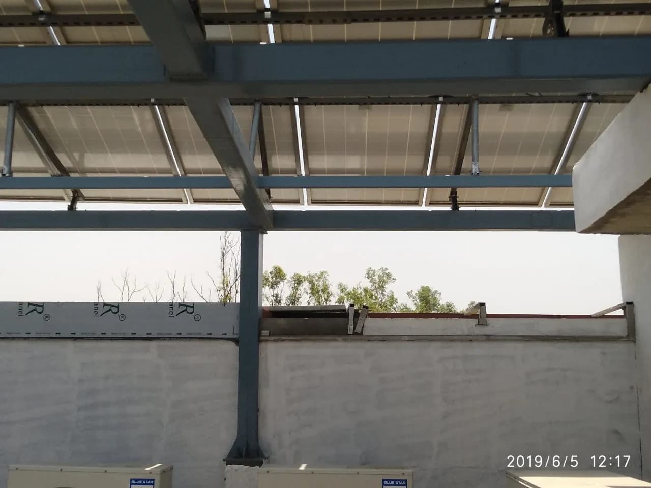 Raised steel support structure beneath solar modules at Tricity Auto