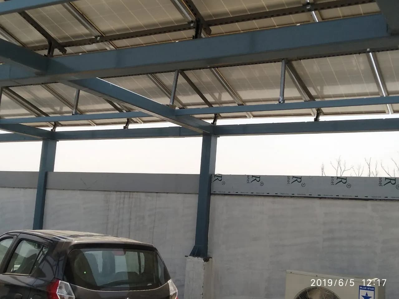 Space beneath the raised solar array with a vehicle and air-conditioning units