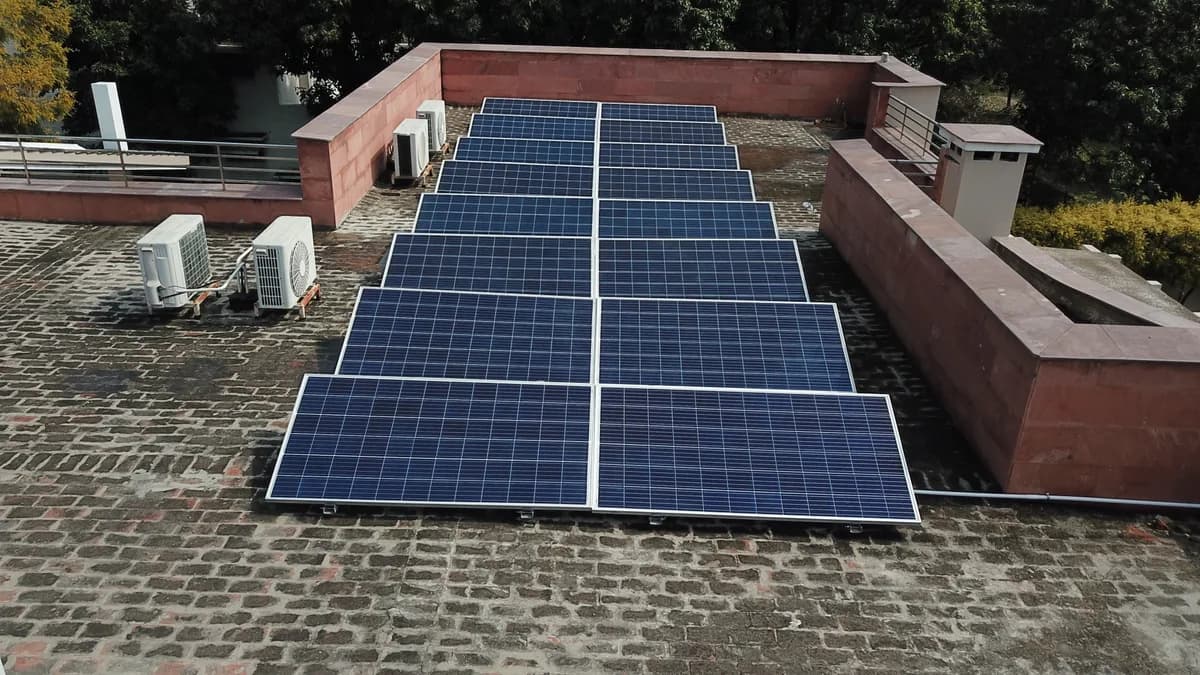 Solar panel rows on a residential terrace with roof access space